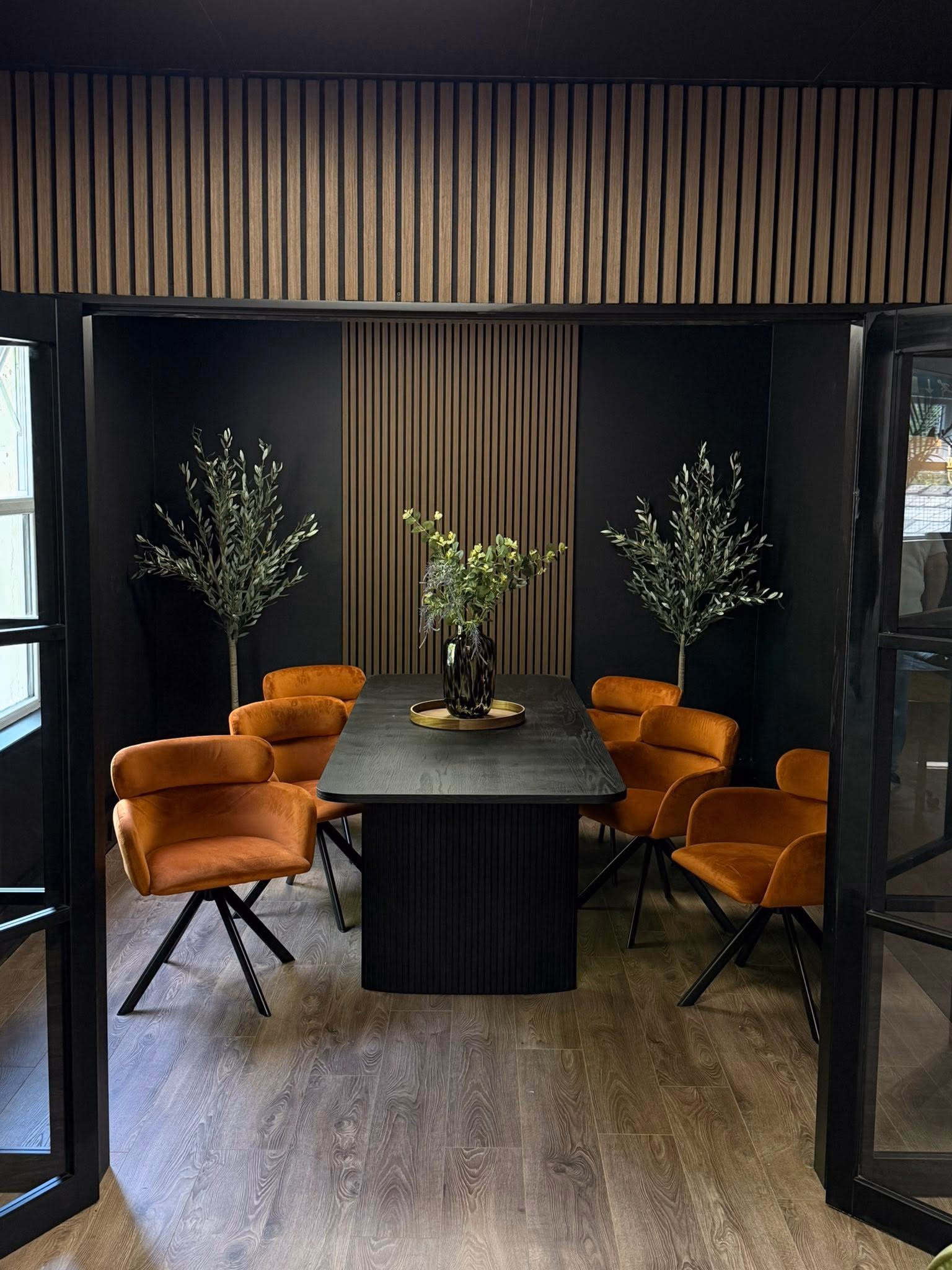 Private meeting room at Howfen House with an oval table and velvet chairs